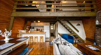 an open living room and kitchen with a loft at Heaven on Hunter in Hunter