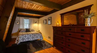 a bedroom with a bed and a dresser at Heaven on Hunter in Hunter