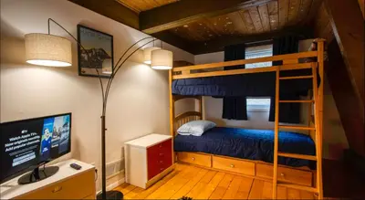 a bedroom with a bunk bed and a computer monitor at Heaven on Hunter in Hunter