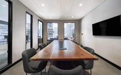 a conference room with a wooden table and chairs at Blueground LES gym doorman near market NYC-1523 in New York