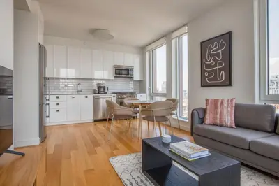 a living room with a couch and a table at Blueground LES gym doorman near market NYC-1523 in New York