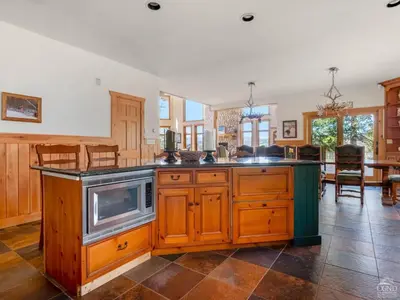 a kitchen with an island with a microwave at Wintertime in Windham