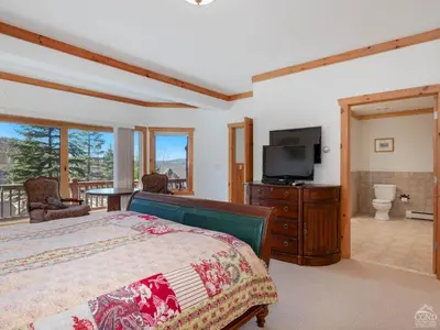 a bedroom with a bed and a flat screen tv at Wintertime in Windham