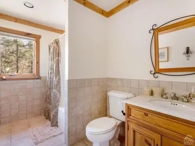 a bathroom with a toilet and a sink and a mirror at Wintertime in Windham