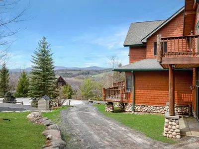 a house with a porch and a driveway at Wintertime in Windham