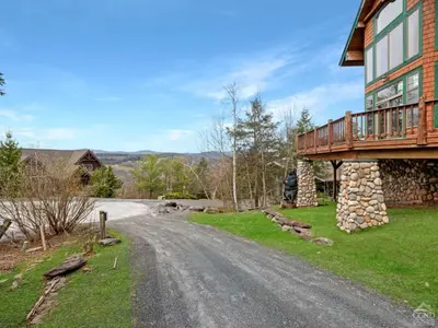 a house on a dirt road next to a house at Wintertime in Windham