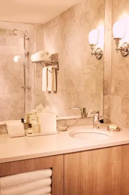 a bathroom with a sink and a mirror at The Tillary Hotel Brooklyn in Brooklyn