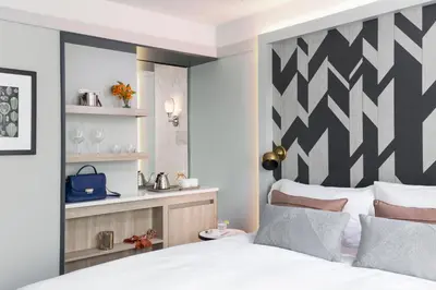 a bedroom with a bed with a black and white headboard at The Tillary Hotel Brooklyn in Brooklyn