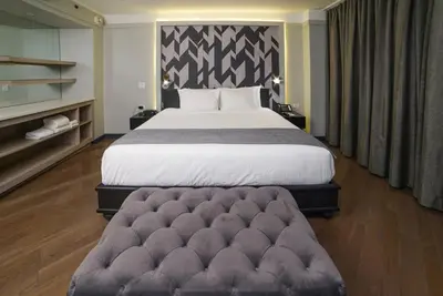 a bedroom with a large bed and a couch at The Tillary Hotel Brooklyn in Brooklyn