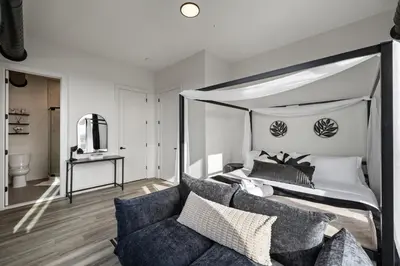 a bedroom with a canopy bed and a couch at Upscale Views 2br Free Parkn, Walk 2 Train, 2bath in East Orange