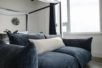 a blue couch in a living room with a window at Upscale Views 2br Free Parkn, Walk 2 Train, 2bath in East Orange