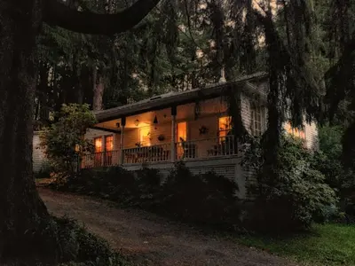 a house in the woods with lights on at Charm at the foot of the Berkshires in Hillsdale