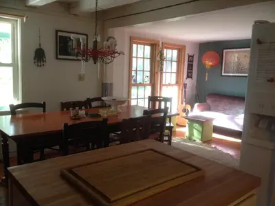 a kitchen and dining room with a table and chairs at Charm at the foot of the Berkshires in Hillsdale