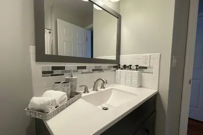 a bathroom with a sink and a mirror at Main Street Stay Westport in Westport