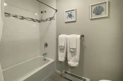a bathroom with a tub and a toilet and towels at Main Street Stay Westport in Westport