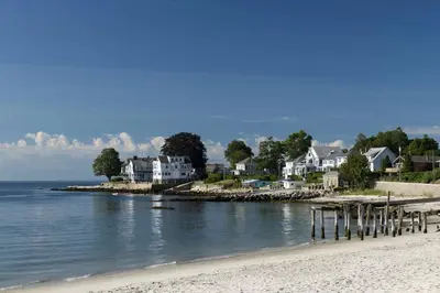 a group of houses on a beach next to the water at Main Street Stay Westport in Westport