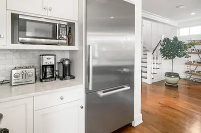 a kitchen with a stainless steel refrigerator and a microwave at Waterside Haven in Branford
