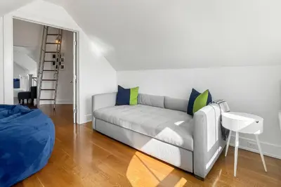 a living room with a couch and a table at Waterside Haven in Branford