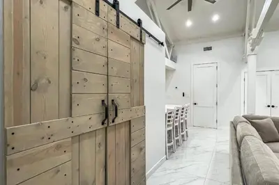 a room with a large wooden closet with wooden doors at Cozy Cottage in Cos Cob in Greenwich