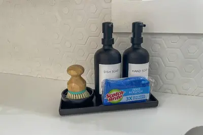 a shelf with two bottles of wine and a small figurine at Cozy Cottage in Cos Cob in Greenwich