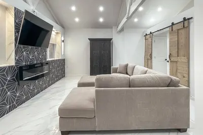 a living room with a couch and a flat screen tv at Cozy Cottage in Cos Cob in Greenwich