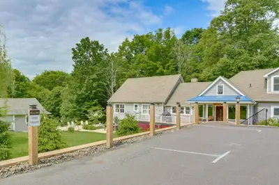 a house with a parking lot in front of it at Hudson Valley Retreat with Pool Near Greenwood Lake in Monroe