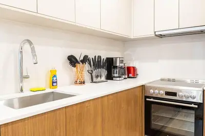 a kitchen with a sink and a counter top at 202 New Condo 1BR in Prime Greenpoint in Brooklyn