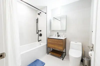a white bathroom with a sink and a toilet at 202 New Condo 1BR in Prime Greenpoint in Brooklyn