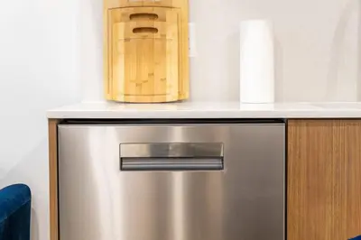 a kitchen with a stainless steel refrigerator with a counter top at 202 New Condo 1BR in Prime Greenpoint in Brooklyn