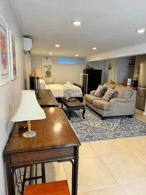 a living room with a couch and a table at Fresh Meadow Studio in Utopia