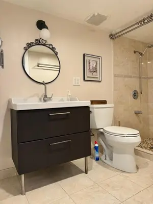 a bathroom with a sink and a toilet and a mirror at Fresh Meadow Studio in Utopia