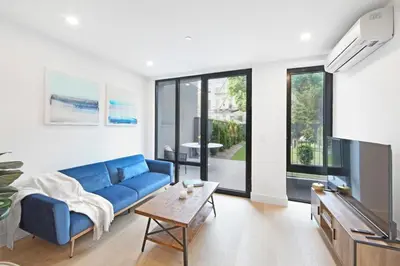 a living room with a blue couch and a tv at 149 Green Street in Brooklyn