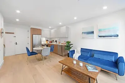 a living room with a blue couch and a table at 149 Green Street in Brooklyn