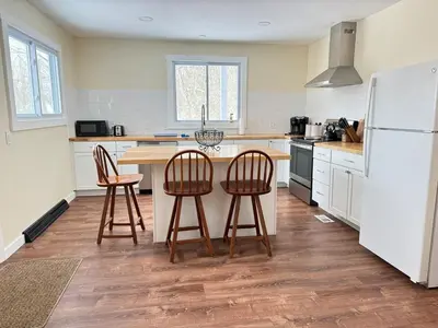 a kitchen with a table and two chairs and a refrigerator at Stay Near Ski Berkshires, Mid-Week & Promo Deals! in New Lebanon