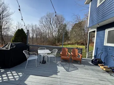 a patio with a table and chairs on a house at Stay Near Ski Berkshires, Mid-Week & Promo Deals! in New Lebanon