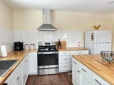 a kitchen with white cabinets and a stove and refrigerator at Stay Near Ski Berkshires, Mid-Week & Promo Deals! in New Lebanon