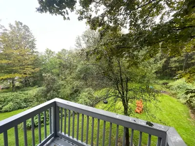 a balcony with a view of a garden at Stay Near Ski Berkshires, Mid-Week & Promo Deals! in New Lebanon