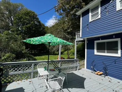 a patio with a table and an umbrella on a house at Stay Near Ski Berkshires, Mid-Week & Promo Deals! in New Lebanon