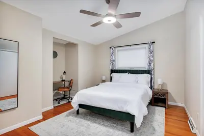 a bedroom with a bed and a ceiling fan at Vacation Home in Albany in Albany