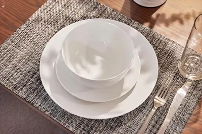a white bowl on a white plate on a table at Vacation Home in Albany in Albany