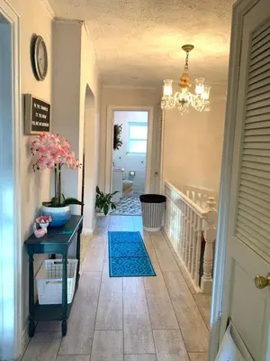a hallway with a table and a chandelier at Cheerful 2 BED ROOMS Apartment in heart of Queens in Jackson Heights