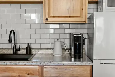 a kitchen counter with a coffee maker and a sink at Ski In Ski Out Hunter Mtn Seasonal Pool Access w Panoramic Views Hike Swim Fish Unwind in Lanesville