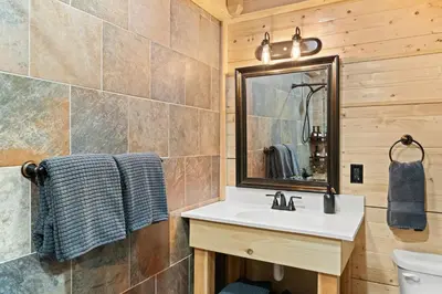 a bathroom with a sink and a mirror at Ski In Ski Out Hunter Mtn Seasonal Pool Access w Panoramic Views Hike Swim Fish Unwind in Lanesville