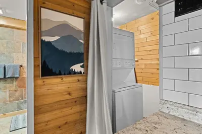 a bathroom with a washer and dryer at Ski In Ski Out Hunter Mtn Seasonal Pool Access w Panoramic Views Hike Swim Fish Unwind in Lanesville