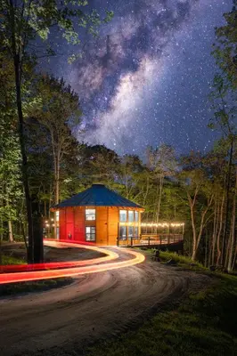 a building on a road at night with a starry sky at Mount Snow Yurt - Hot Tub, Wood Stove, WiFi, EVcharger in Dover
