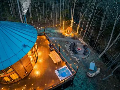 an aerial view of a tree house in the woods at night at Mount Snow Yurt - Hot Tub, Wood Stove, WiFi, EVcharger in Dover