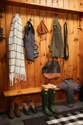 a wooden wall with clothes and shoes and boots at Cozy Lux Mountain Lodge Hot Tub Mtn Views Skiing in Jewett
