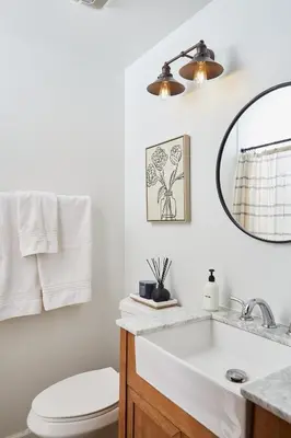 a bathroom with a sink and a toilet and a mirror at Cozy Lux Mountain Lodge Hot Tub Mtn Views Skiing in Jewett