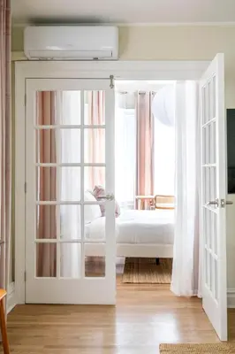 a bedroom with a door leading to a bed at Bright & Modern - 35 Mins to NYC - Extended Stays in Jersey City