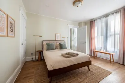 a bedroom with a bed and a window at Bright & Modern - 35 Mins to NYC - Extended Stays in Jersey City